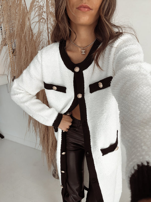 long white cardigan with antique brass buttons. Black trim detailing. chic, cozy long sweater. chanel designer sweater. brooklyn blvd. brooklyn boulevard.