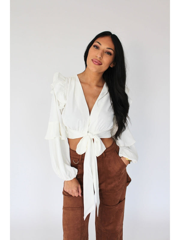 A Line and Dot tie-front white long sleeve blouse - Elevate your style with this chic piece featuring ruffle details on the sleeve. Effortlessly stylish and perfect for any occasion